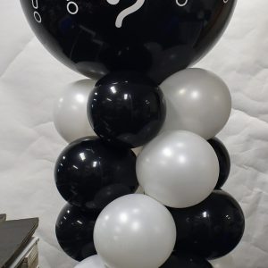 a column of 20 balloons with a large black balloon on top. When poped small balloons will come flying out iin either blue or pink to reveal the gender.